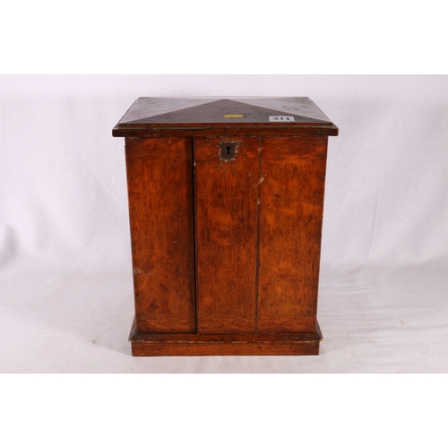 311 - 19th century oak apprentice's type table top cabinet chest with peaked top, the doors opening to rev... 