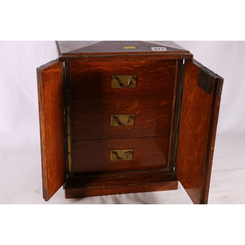 311 - 19th century oak apprentice's type table top cabinet chest with peaked top, the doors opening to rev... 