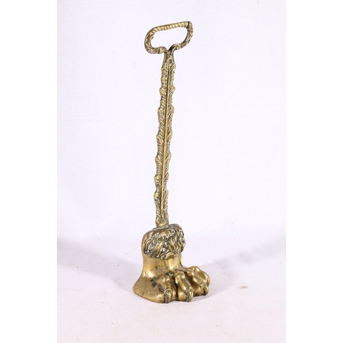 319 - Brass door stop in the form of a lion paw, 38cm tall