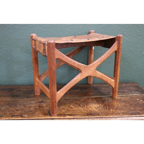 345 - GORDON RUSSELL (1892-1980) an Arts and Crafts oak a leather stool with X frame and chamfered support... 