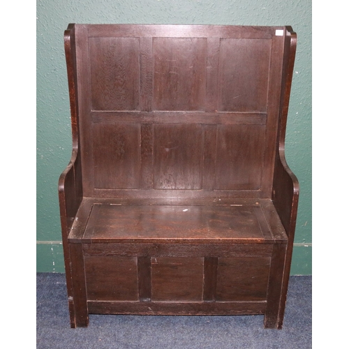 372 - 19th century oak settle with high panel back, lift up storage seat and fielded panel base, 124cm tal... 