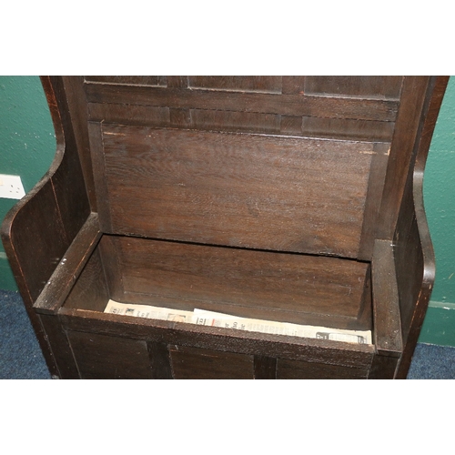 372 - 19th century oak settle with high panel back, lift up storage seat and fielded panel base, 124cm tal... 