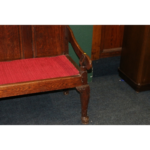 388 - Antique oak settle day bed with quintuple panel back, slip in seat and scroll arms raised on cabriol... 