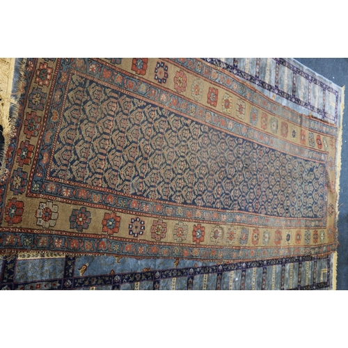 457 - A Faraham rug of typical design, over blue ground, triple foliate border, 290 x 118 cm