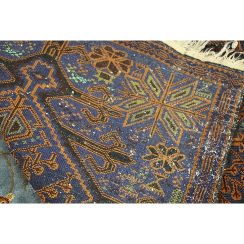 458 - A Pavilion rug, central lozenge with tree design, spondral one blue ground, inter trimmed border, 12... 