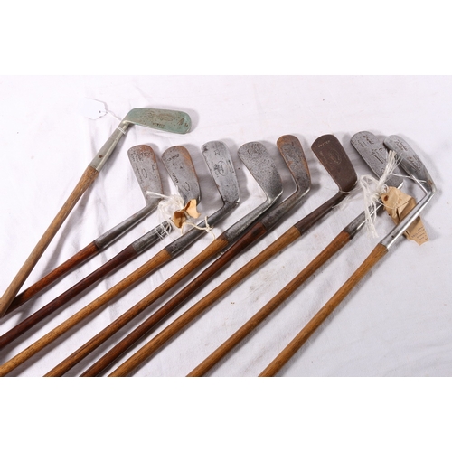 Nine hickory shafted golf clubs including Schneider stainless