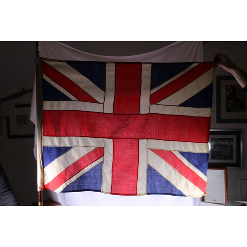 438 - British flag bearer's pole and Union Jack with brass spike finial, 227cm long, with leather carrying... 