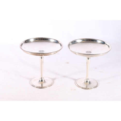 69 - Pair of American silver tazzas, the dish tops engraved with MKB monogram, raised on tapering stems a... 