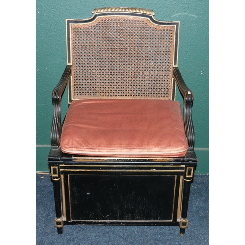 526 - 19th century ebonised commode chair with bergere back and seat, reeded scroll arms and raised on pan... 