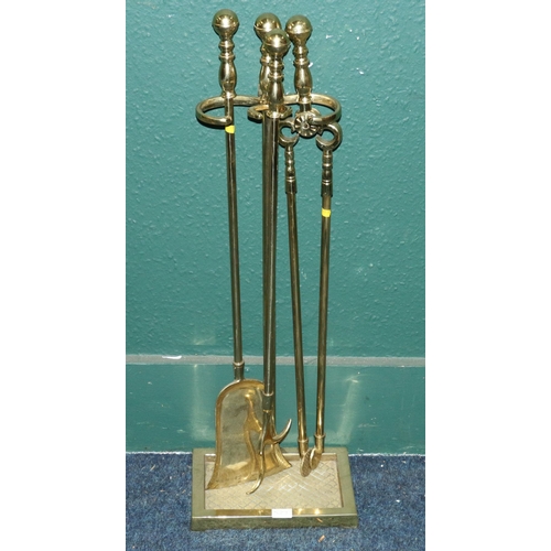 539 - Brass three piece fire companion set on stand, 78cm tall