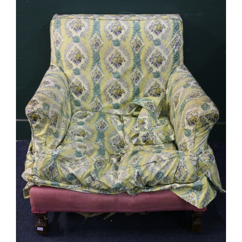 548 - 19th century oversize lounge chair with yellow floral cover raised on turned and block supports unit... 