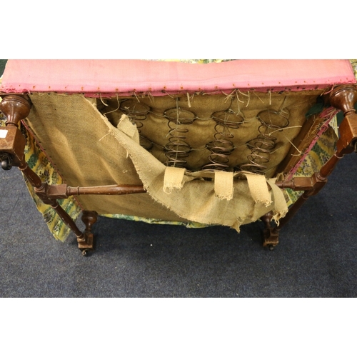 548 - 19th century oversize lounge chair with yellow floral cover raised on turned and block supports unit... 