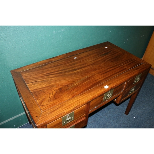 553 - Early 20th century Oriental hardwood desk, the rectangular crossbanded top above an arrangement of f... 