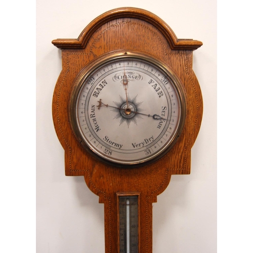 242 - Late 19th century or early 20th century oak barometer, the moulded arched pediment over brushed meta... 