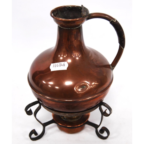 246 - 19th century Aesthetic copper jug on stand with scrolling legs over burner, 21cm high.