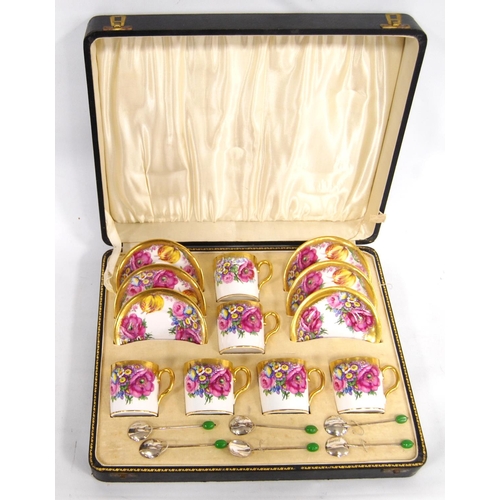 249 - Cased gilt and floral coffee set comprising six cups, six saucers and six Birmingham silver spoons.