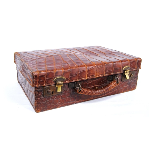 285 - Vintage crocodile skin case with brass locks, monogrammed 'M.B.', 38cm wide, 12cm high and 25cm deep... 