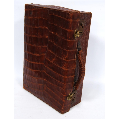 285 - Vintage crocodile skin case with brass locks, monogrammed 'M.B.', 38cm wide, 12cm high and 25cm deep... 