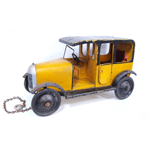 287 - 1930s Lines Brothers Tri-ang wooden model of a taxi in yellow and black, 47cm long and 27cm high.