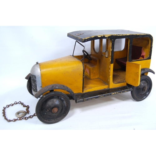 287 - 1930s Lines Brothers Tri-ang wooden model of a taxi in yellow and black, 47cm long and 27cm high.