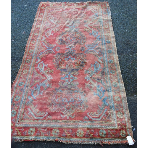 300 - Turkoman rug with four medallions over red ground, spandrels and floral border, 265cm x 136cm.