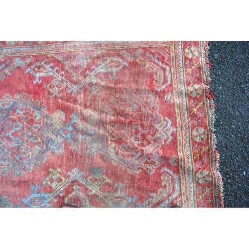 300 - Turkoman rug with four medallions over red ground, spandrels and floral border, 265cm x 136cm.