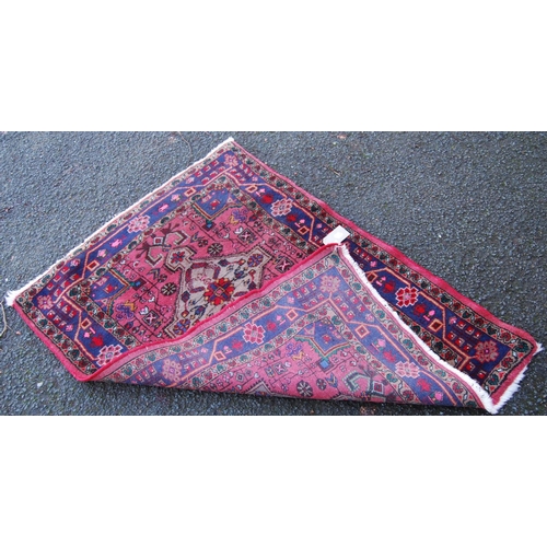 301 - Hamadan rug with two central medallions over floral pink ground, triple border, 120cm x 95cm.