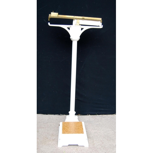 302 - Set of scales with brass rule and weight, on cast iron pedestal and plinth base, 125cm high.