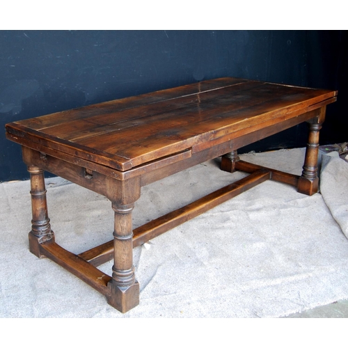 305 - 18th century style refectory table with rectangular plank top enclosing leaves, raised on block and ... 