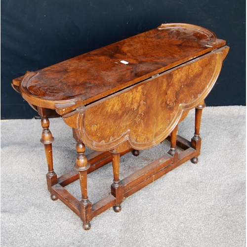 311 - Queen Anne style burr walnut gate-leg table, the scalloped drop-flap top raised on baluster turned l... 