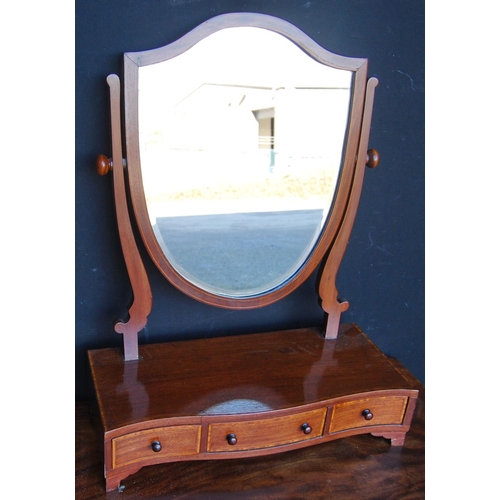 312 - Mahogany serpentine dressing glass, the boxwood strung shield shaped swing mirror on serpentine supp... 