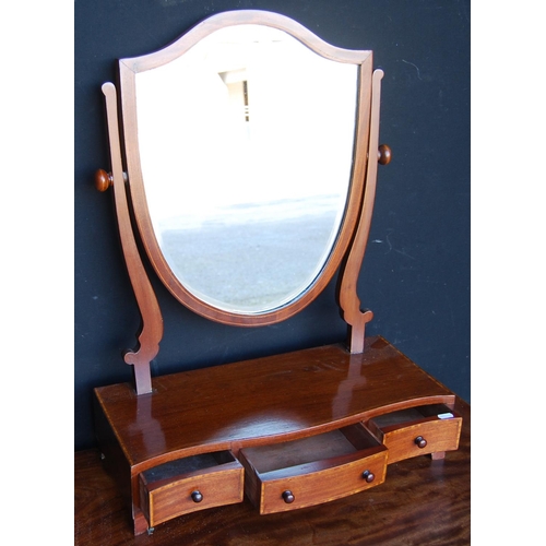 312 - Mahogany serpentine dressing glass, the boxwood strung shield shaped swing mirror on serpentine supp... 