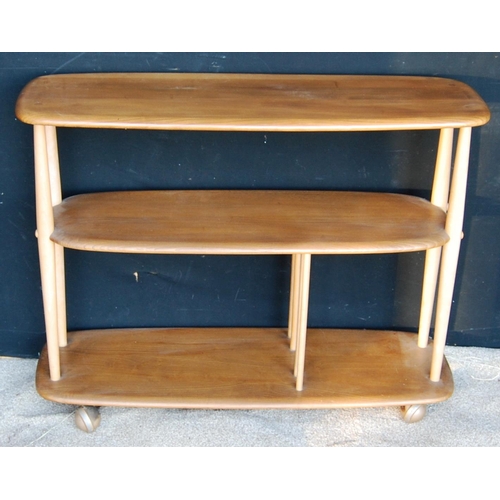 327 - Ercol open bookcase with rounded rectangular top and shelves, raised on tapering turned supports and... 