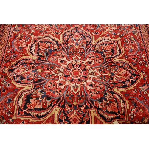 333 - Carpet with central rosette over all over floral design, spandrels and triple border, 410cm x 295cm.