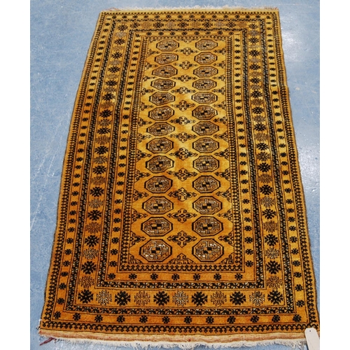 337 - Afghan rug with two rows of thirteen guls over orange ground and star border, 196cm x 110cm.