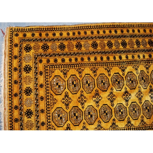 337 - Afghan rug with two rows of thirteen guls over orange ground and star border, 196cm x 110cm.