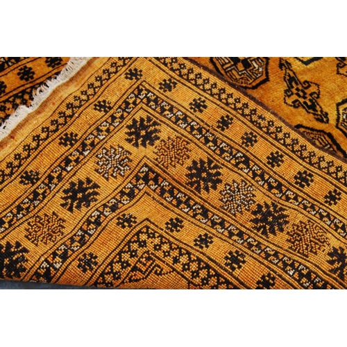 337 - Afghan rug with two rows of thirteen guls over orange ground and star border, 196cm x 110cm.