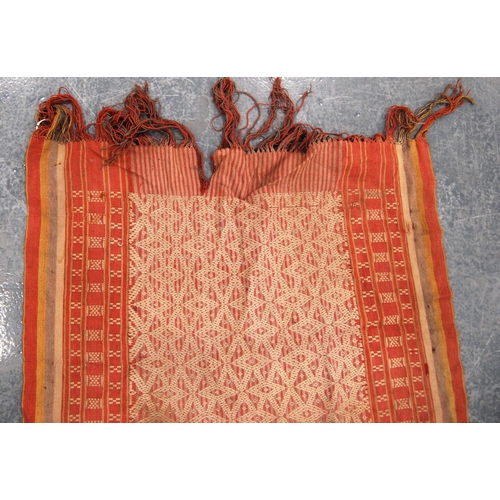 338 - Shawl with geometric design, red ground and border, 120cm x 61cm.