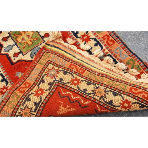 342 - Turkey runner with seven medallions over orange ground and double border, 300cm x 74cm.