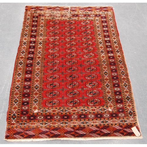 344 - Tekke rug with three rows of thirteen guls over red ground and multiple border, 184cm x 123cm.