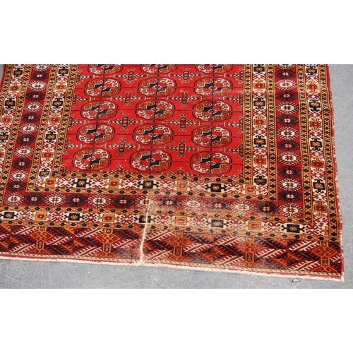 344 - Tekke rug with three rows of thirteen guls over red ground and multiple border, 184cm x 123cm.