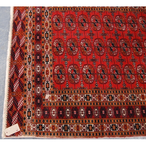 344 - Tekke rug with three rows of thirteen guls over red ground and multiple border, 184cm x 123cm.