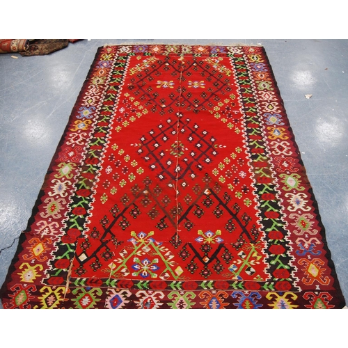 349 - Thracian Kilim carpet with floral diamonds over red ground, double border, 336cm x 216cm.