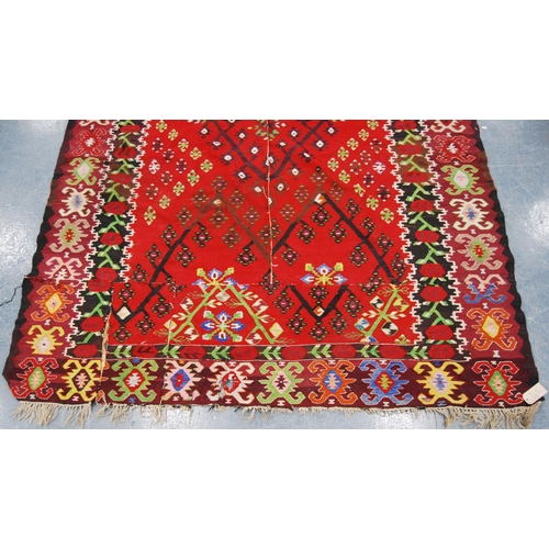 349 - Thracian Kilim carpet with floral diamonds over red ground, double border, 336cm x 216cm.