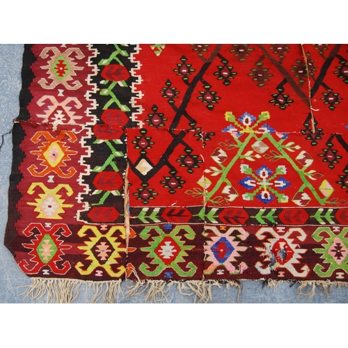 349 - Thracian Kilim carpet with floral diamonds over red ground, double border, 336cm x 216cm.