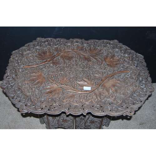 353 - Ceylonese occasional table with elaborate floral carved top and stand, 83cm wide, 60cm high and 56cm... 