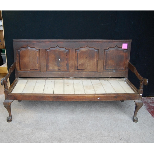 378 - 18th century oak settle with crossbanded panelled back over open arms, raised on cabriole legs termi... 