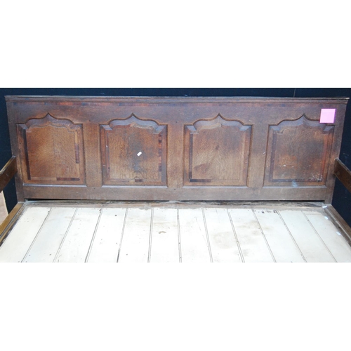 378 - 18th century oak settle with crossbanded panelled back over open arms, raised on cabriole legs termi... 