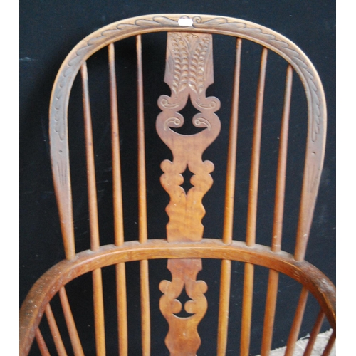 381 - Windsor chair, the comb back with carved pierced central splat, hoop arms, baluster turned supports ... 