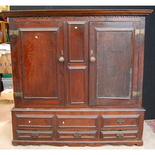 384 - Georgian oak hall cabinet, the projected moulded cornice over panelled doors over stepped base with ... 